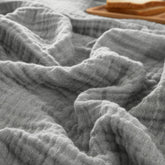 PHF blanket front view showing grey minimalist packaging and soft appeal