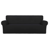 PureFit front view on large black sofa showing sleek protection and renewed look