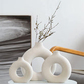 QLOFEI front view of three white donut vases showing balanced modern silhouette and styling benefit