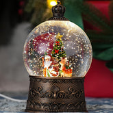 Qukulov front view snow globe showing lit Santa scene and cozy ambiance