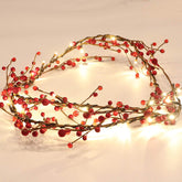 Rhytsing front view of garlands showing red berries and warm lights, festive appeal