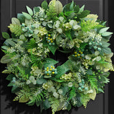 Rimalo wreath on front door adding welcoming greenery and curb appeal