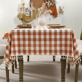 Romanstile front view of orange gingham tablecloth showing full pattern and drape benefits