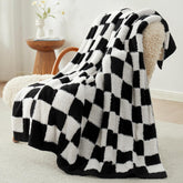 Snuggle Sac front view on sofa showing black checker elegance and cozy appeal