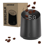 Subminimal SubScale front view showing compact dosing cup and matte black finish for neat counters