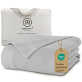 Threadmill folded blanket front view showing light grey color and plush look
