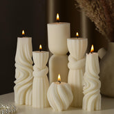 Threlaco front view of six white ribbed pillar candles showing set variety and styling benefit