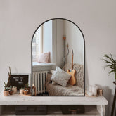 TRAHOME arched mirror front view showing sleek matte black frame and balanced proportions