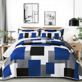 Tyrot front view of quilt on bed showing modern patchwork and refreshed décor