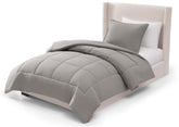 UGG Leonora front view on bed showing seal grey comforter and clean aesthetic
