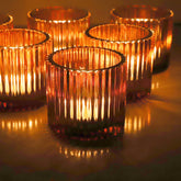 VOHO front view of amber votive holder showing vintage fluted shape and warm glow
