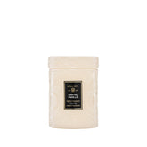 Voluspa Santal Vanille front jar showing white glass and candle glow benefit: elegant décor