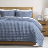 WDCOZY quilt front view showing dusty blue color and elegant drape