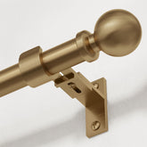 Wolistsa front view of warm gold curtain rod showing elegant profile and strength