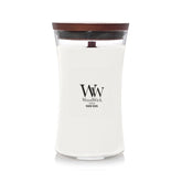 WoodWick Warm Wool hourglass front view showing elegant glass and cozy scent benefit