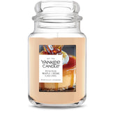 Yankee Candle front jar view showing warm pumpkin-maple scent benefit