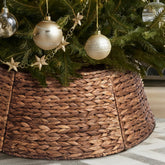 Yonsya rattan tree collar front view showing rustic finish and tidy base concealment