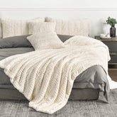 YUSOKI front view of folded ivory blanket showing plush look and inviting warmth