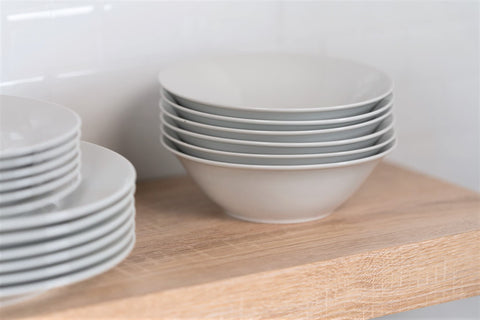 10 Strawberry Street bowl next to spoon for scale showing ideal 7-inch serving size