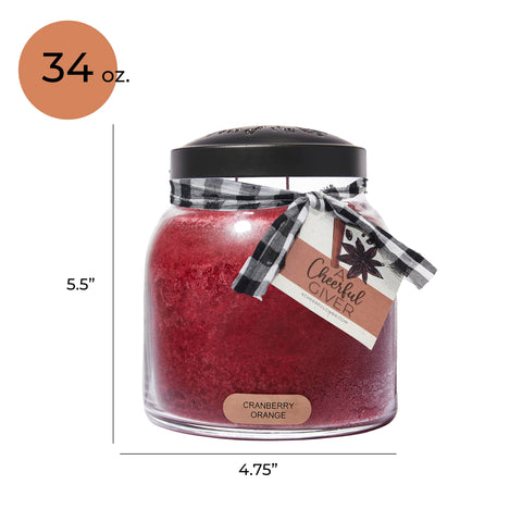 A Cheerful Giver candle next to a soda can showing 34oz scale and long burn time