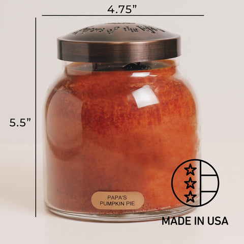 A Cheerful Giver candle held in a hand for scale showing 34oz size and substantial burn time