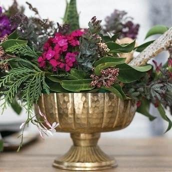 Accent Decor Lita holding floral arrangement to illustrate decorative and event styling versatility