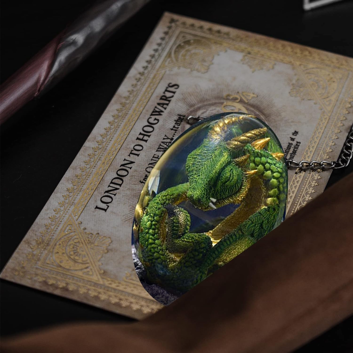 ACOCOFE dragon egg next to hand for scale showing compact collectible size