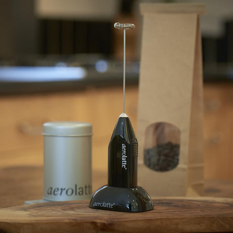 Aerolatte frother creating foam in a mug to quickly upgrade homemade coffee