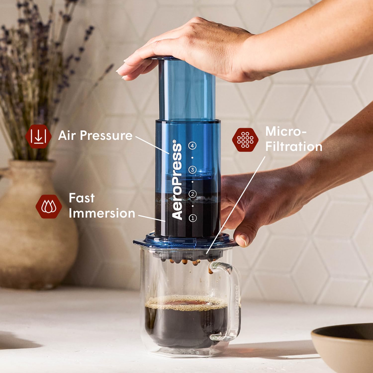 AeroPress clear blue plunger close-up showing smooth press for richer extraction