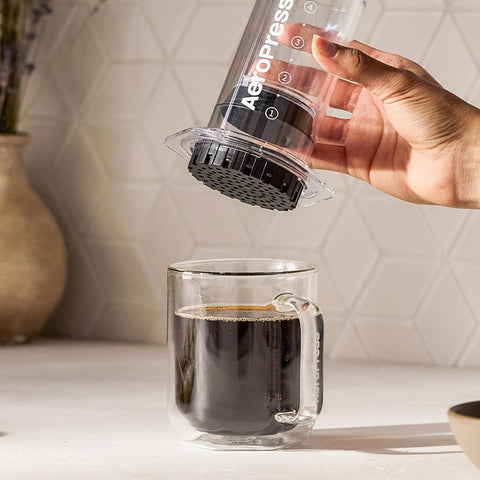 AeroPress Clear packed in a backpack illustrating lightweight build and on-the-go brewing