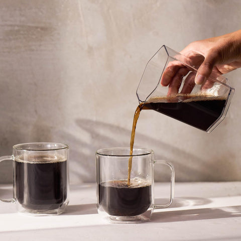 AeroPress Clear XL packed in a backpack showing portable, shatterproof design for travel