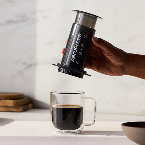 AeroPress in hand showing compact size and lightweight portability