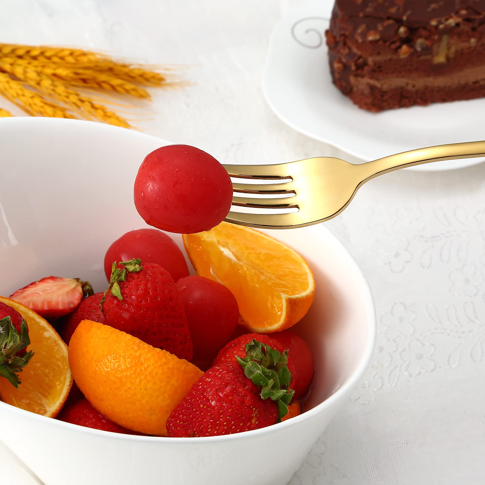 Aisoso flatware beside a dinner plate demonstrating real-world scale and fit