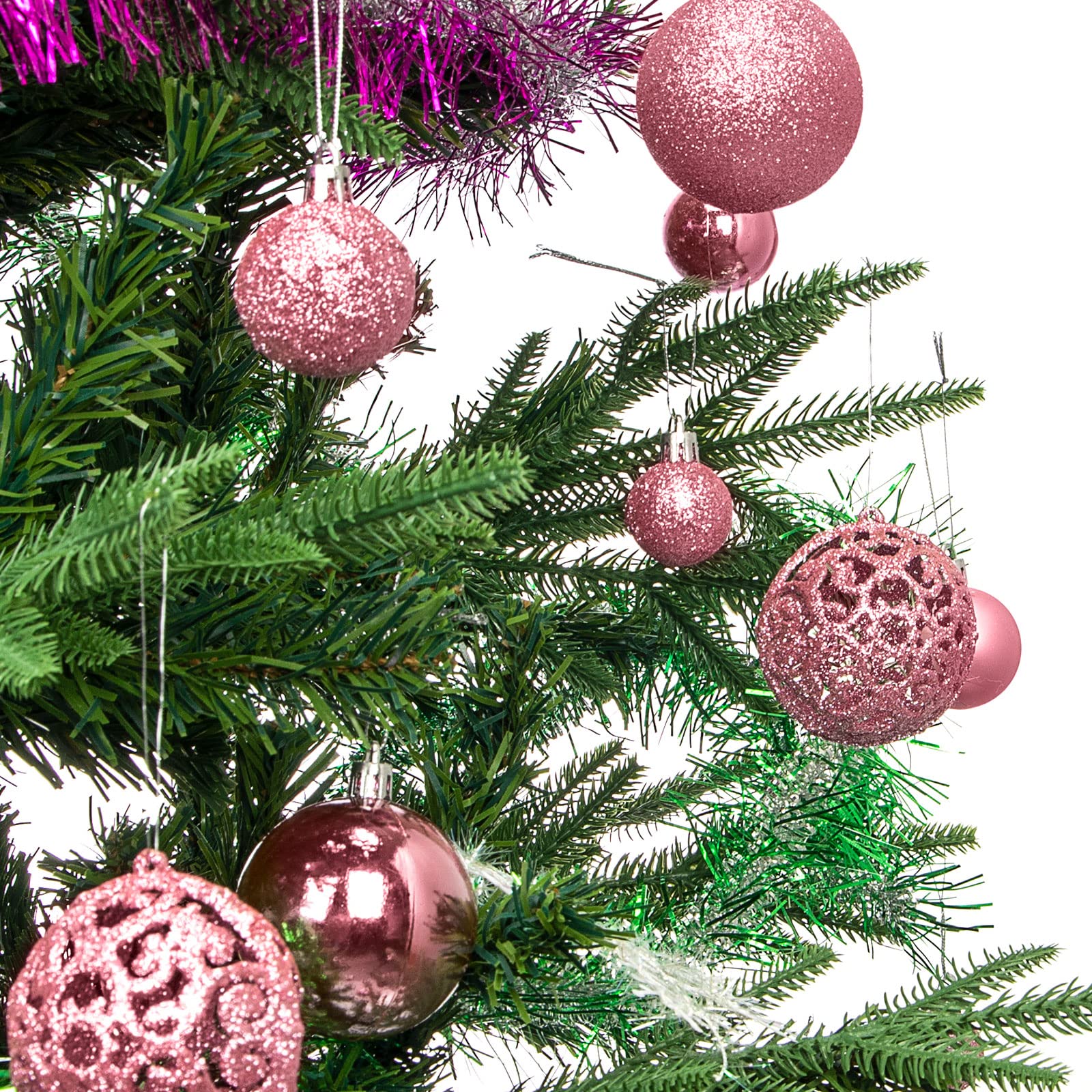 Aitsite ornaments hung on a lit Christmas tree for festive ambiance
