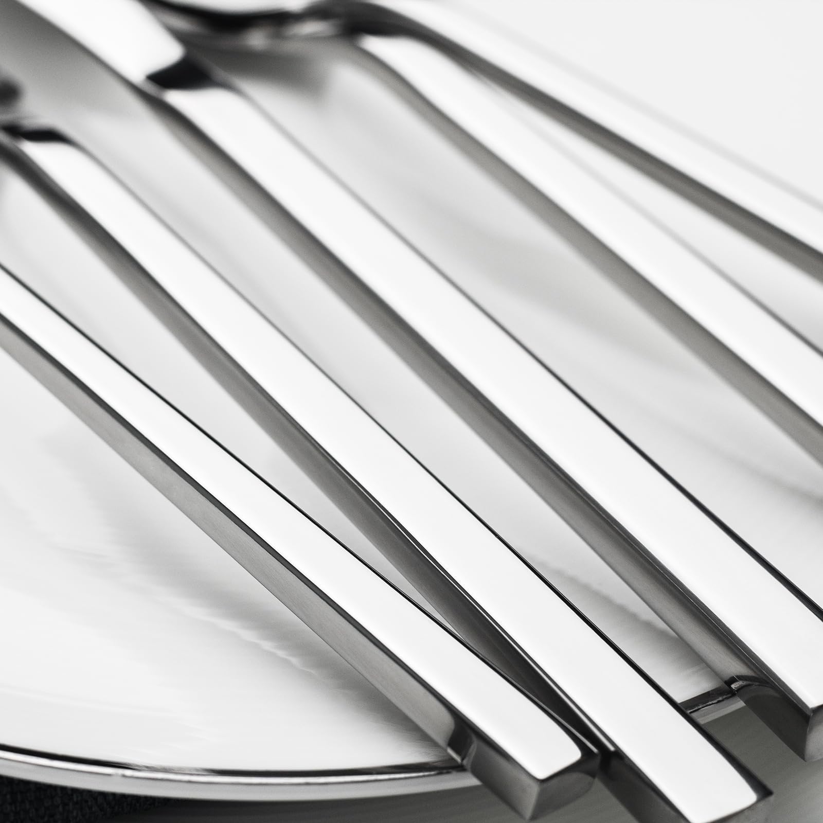 Alata flatware arranged on a dining table enhancing meal presentation