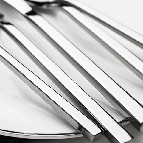 Alata flatware arranged on a dining table enhancing meal presentation