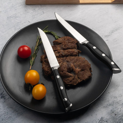 Alata lifestyle table setting featuring knives enhancing plated steak presentation