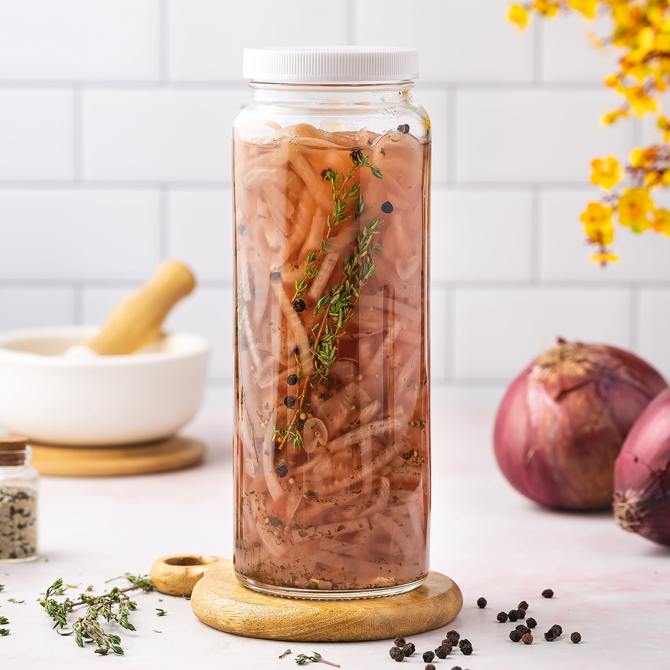 All About Juicing bottles on breakfast table with fruit, suggests ready-to-serve presentation