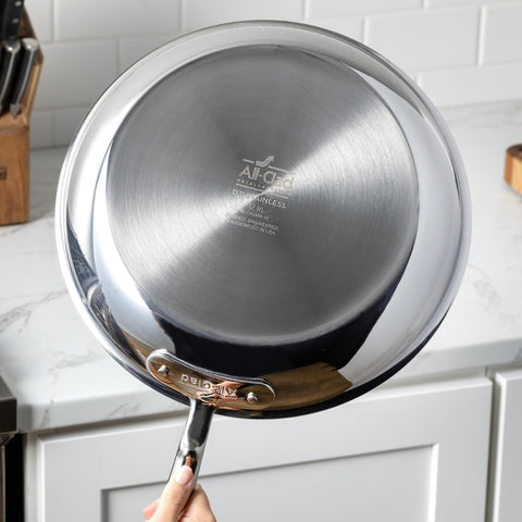 All-Clad D3 with measuring cup to show 1.5-quart scale and portioning benefit