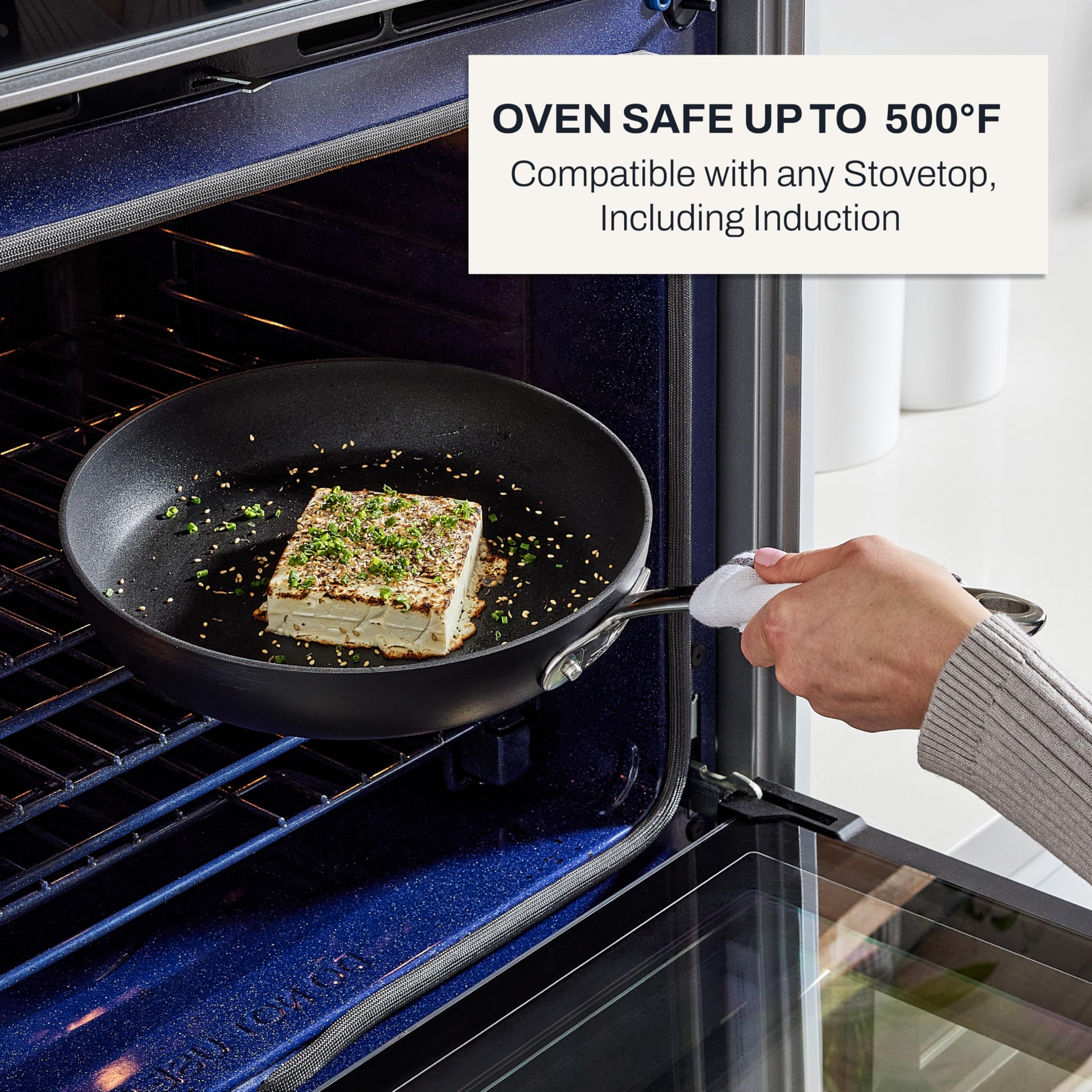 All-Clad HA1 skillet in use searing a steak demonstrating high-heat performance