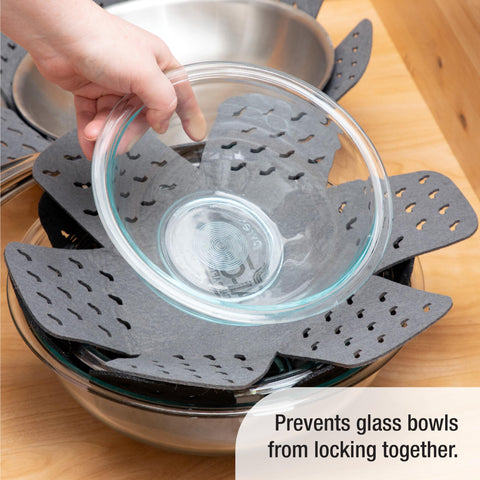 All-Clad nested pots in cabinet using protectors to prevent dents and scuffs