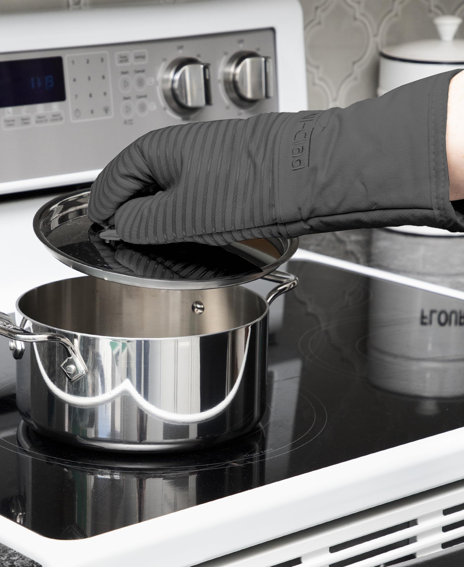 All-Clad mitts next to ruler showing 14-inch coverage for wrist protection