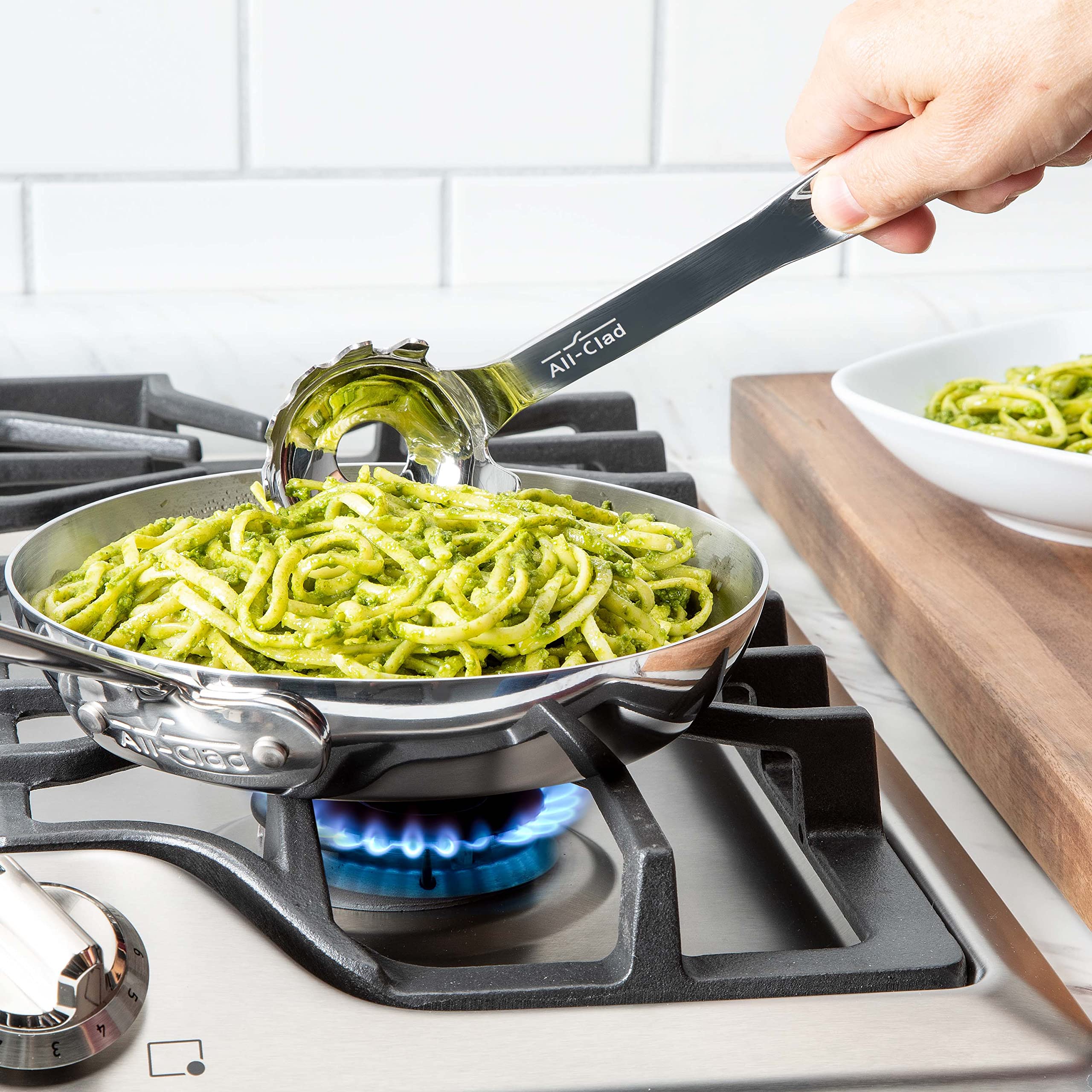 All-Clad ladle handle and center drain close-up highlighting ergonomic grip and quick draining