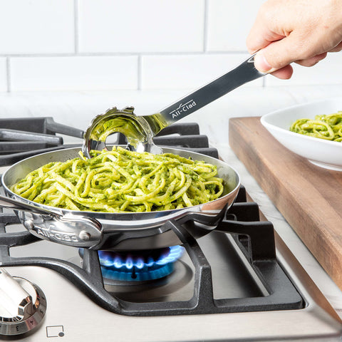 All-Clad ladle handle and center drain close-up highlighting ergonomic grip and quick draining