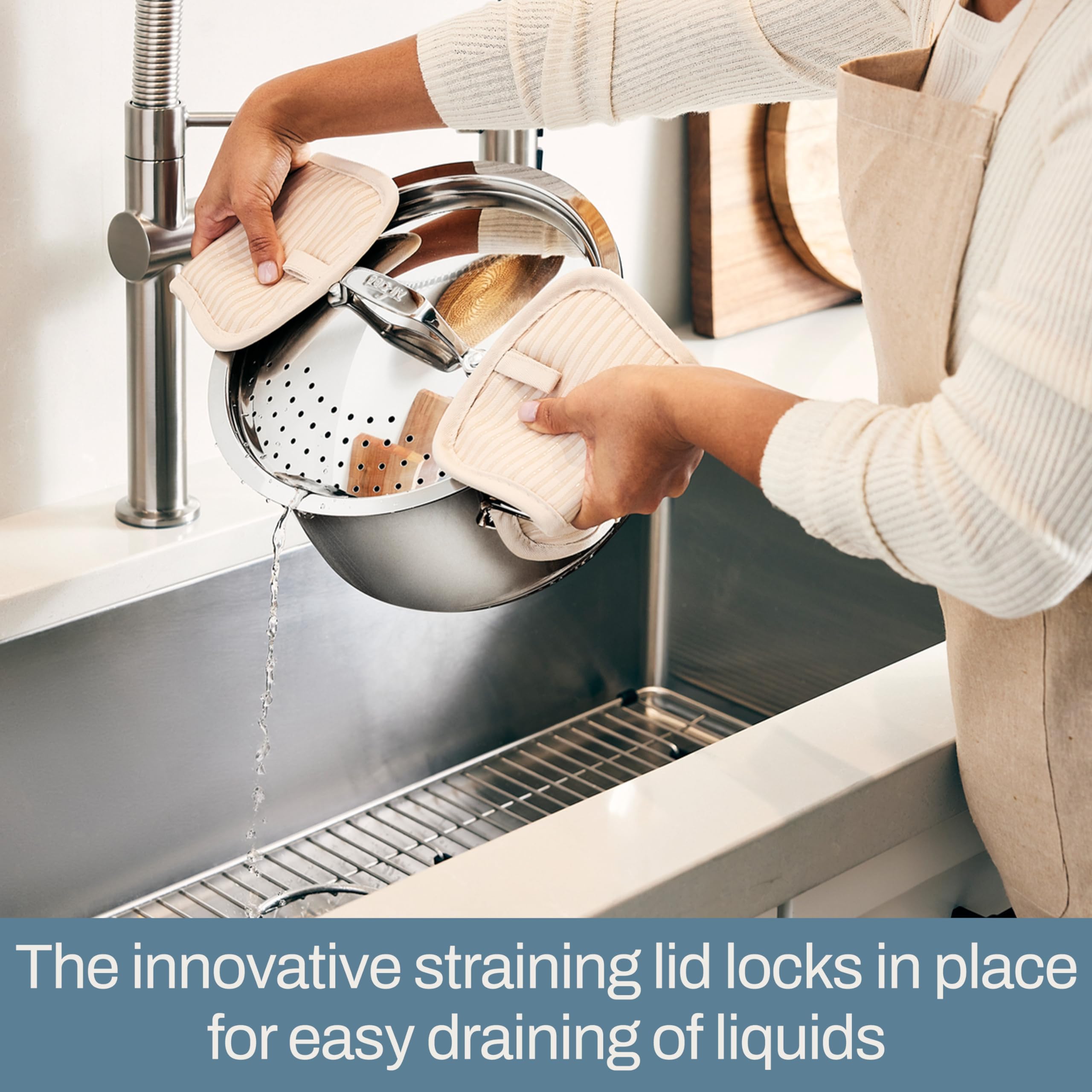 All‑Clad view of extra‑wide handles providing safe oven mitt grip and stability