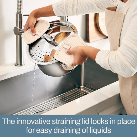 All‑Clad view of extra‑wide handles providing safe oven mitt grip and stability