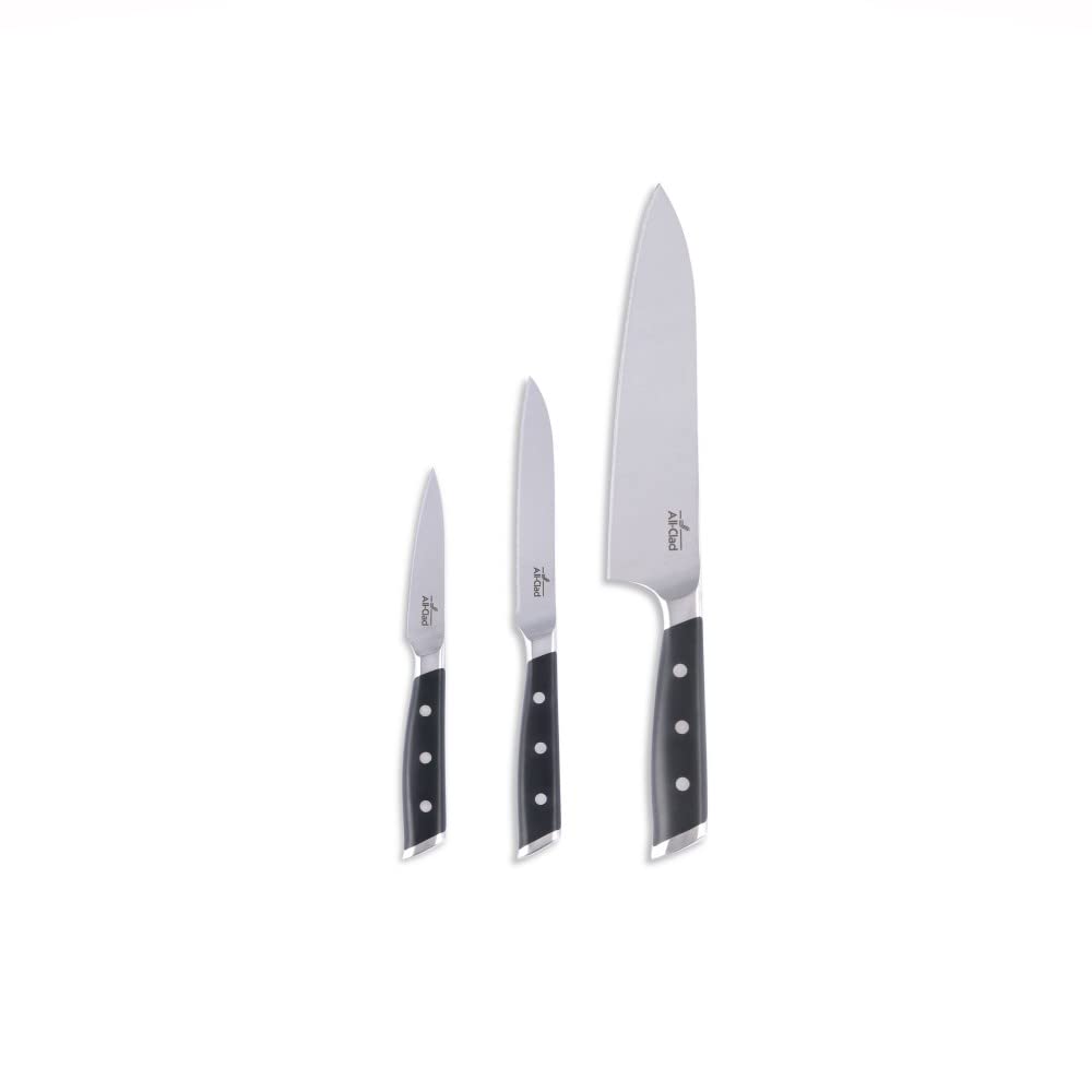 All-Clad knives next to cutting board showing scale and drawer-friendly compactness