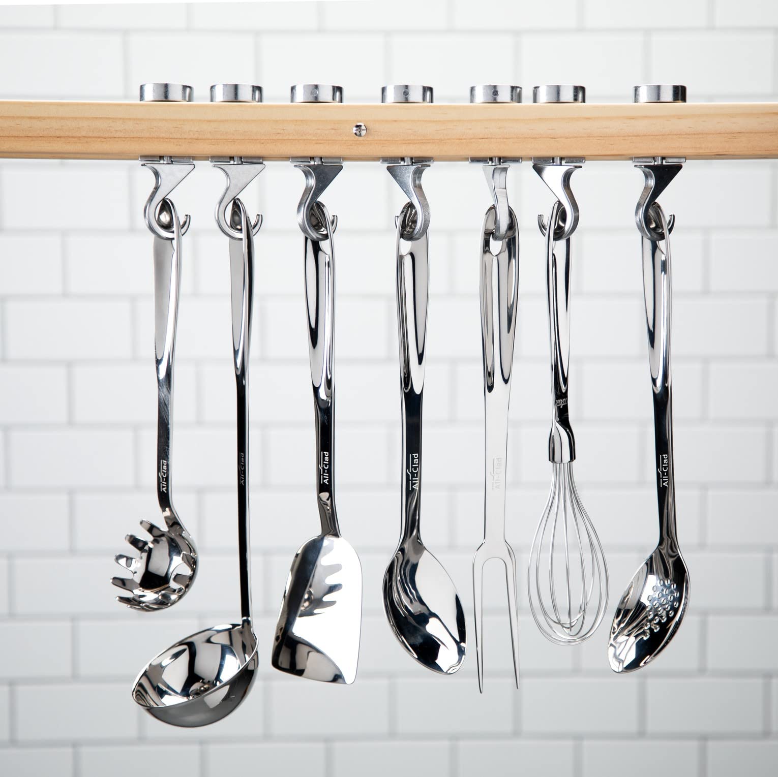 All-Clad spoon hanging on rack for easy storage and compact kitchen convenience