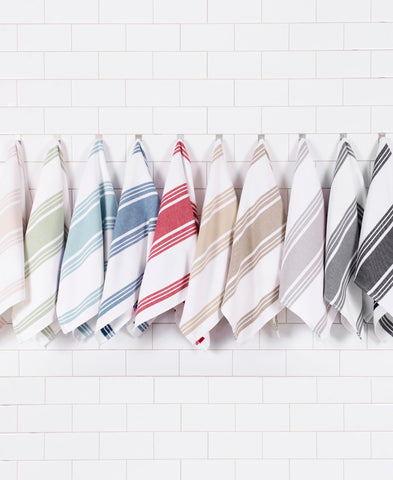 All-Clad towels styled on kitchen counter coordinating with cookware benefit
