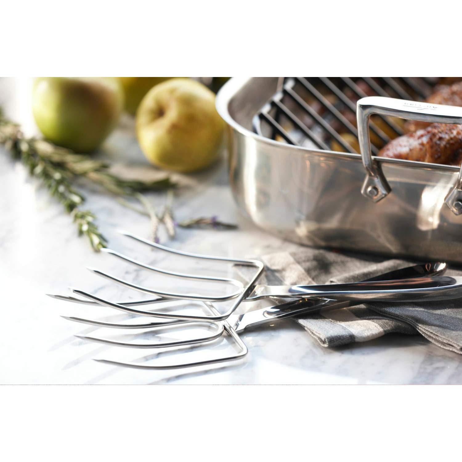 All-Clad turkey forks lifting roasted turkey with stable grip for safe transfer and carving